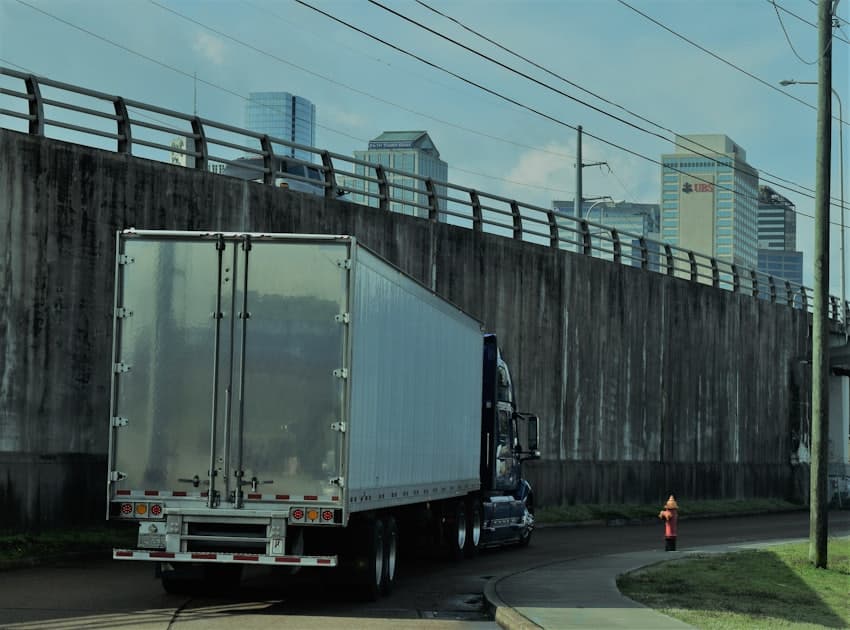 Ledger and calculator analyzing truck operating costs